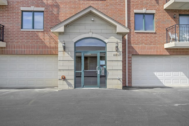 6850 W Winding Trl Unit 406, Oak Forest, IL 60452 - property entrance featuring brick siding, driveway, and a balcony