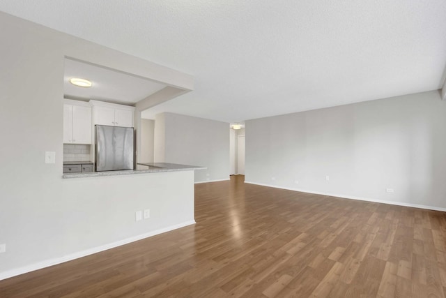 801 S Plymouth Ct Unit 711, Chicago, IL 60605 - unfurnished living room featuring dark wood-type flooring and baseboards