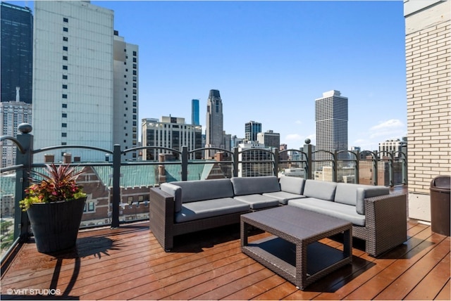 wooden terrace with an outdoor living space and a view of skyline