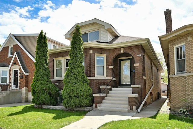 6211 W School St, Chicago, IL 60634 - view of front facade featuring entry steps, brick siding, and a front yard