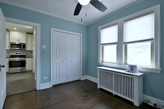 6211 W School St, Chicago, IL 60634 - bedroom featuring radiator heating unit, dark wood-type flooring, baseboards, a closet, and ornamental molding