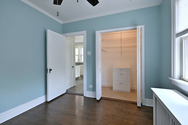 6211 W School St, Chicago, IL 60634 - unfurnished bedroom with dark wood-style floors, crown molding, baseboards, a closet, and ceiling fan
