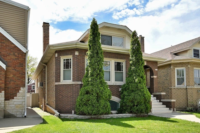 6211 W School St, Chicago, IL 60634 - view of front facade featuring a chimney, brick siding, and a front lawn