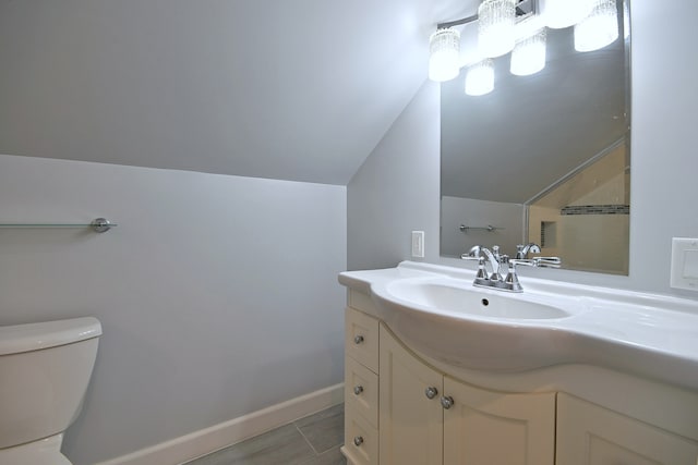 6211 W School St, Chicago, IL 60634 - bathroom with vaulted ceiling, toilet, vanity, and baseboards
