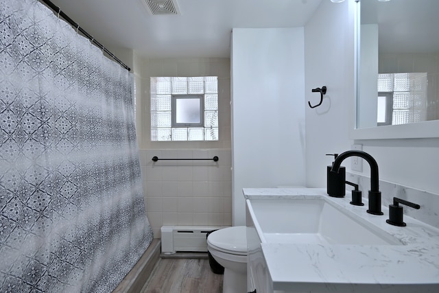 6211 W School St, Chicago, IL 60634 - bathroom featuring a baseboard radiator, toilet, a shower with curtain, wood finished floors, and vanity