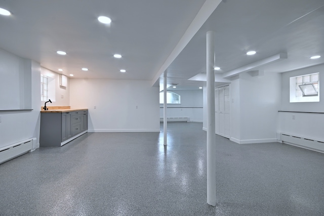 6211 W School St, Chicago, IL 60634 - below grade area with a baseboard radiator, recessed lighting, baseboards, and plenty of natural light