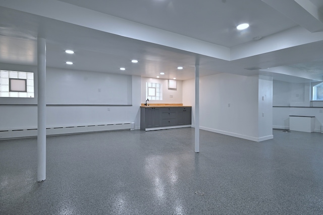 6211 W School St, Chicago, IL 60634 - below grade area featuring baseboards, recessed lighting, and a baseboard radiator