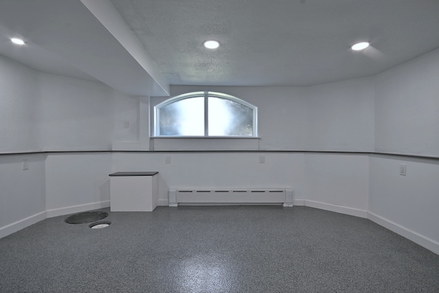 6211 W School St, Chicago, IL 60634 - empty room with a baseboard radiator, recessed lighting, baseboards, and a textured ceiling