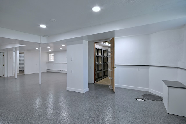 6211 W School St, Chicago, IL 60634 - finished below grade area featuring a baseboard radiator, recessed lighting, and baseboards