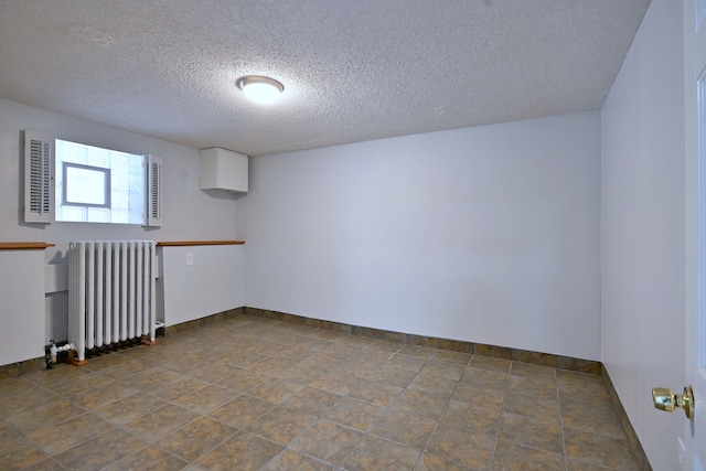 6211 W School St, Chicago, IL 60634 - unfurnished room featuring radiator, a textured ceiling, and baseboards