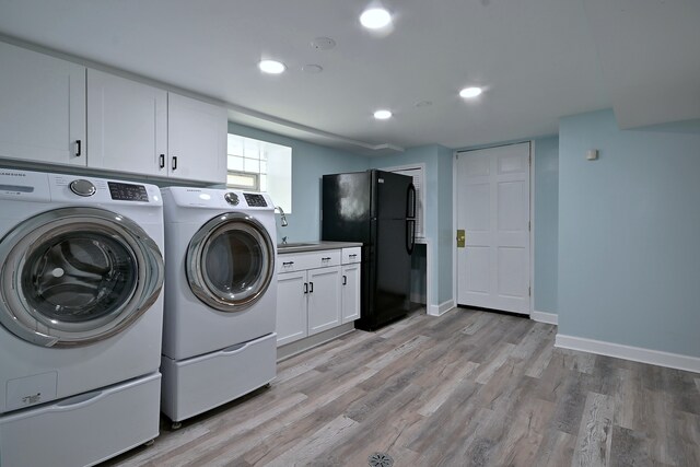 6211 W School St, Chicago, IL 60634 - washroom featuring separate washer and dryer, baseboards, light wood-type flooring, recessed lighting, and cabinet space