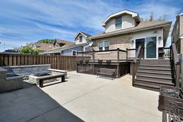 6211 W School St, Chicago, IL 60634 - back of property featuring a fire pit, a patio area, a deck, brick siding, and fence