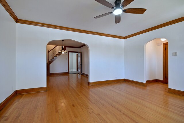 6211 W School St, Chicago, IL 60634 - spare room with arched walkways, crown molding, ceiling fan, baseboards, and light wood-style flooring