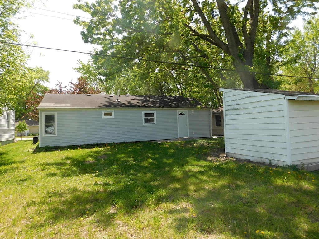 271 Toni St, Bourbonnais, IL 60914 - back of property with a lawn, an outbuilding, and a storage shed
