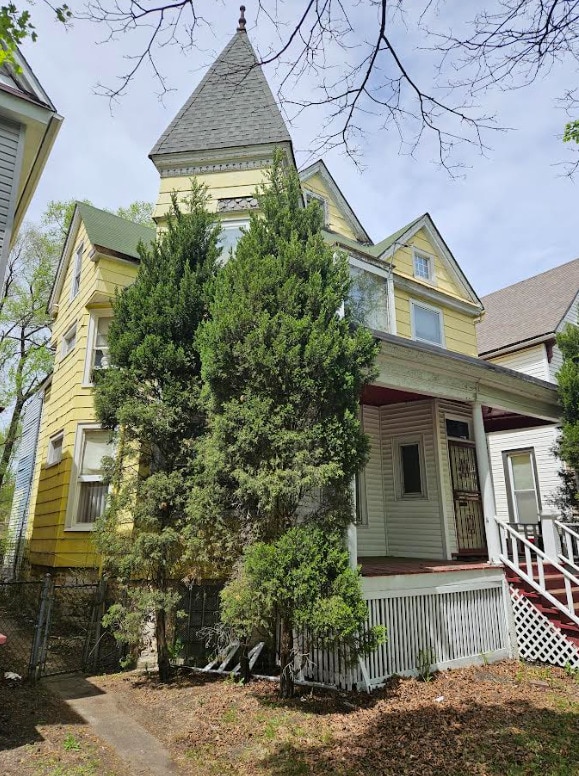 6550 S Stewart Ave, Chicago, IL 60621 - victorian house featuring a porch and fence