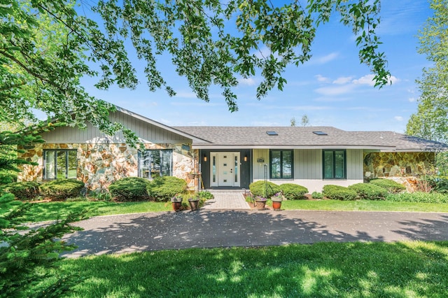 8311 Haligus Rd, Huntley, IL 60142 - ranch-style home featuring stone siding, a front lawn, and roof with shingles