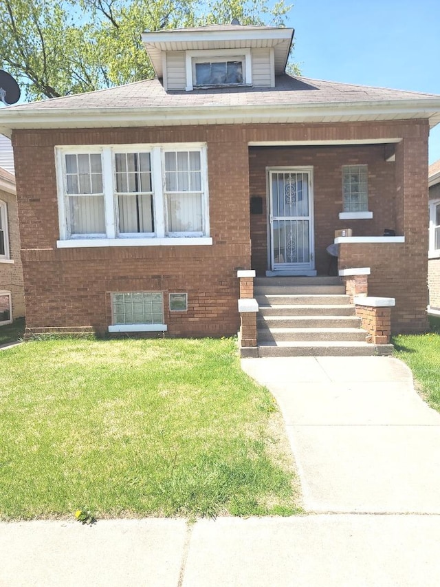 2638 Grove Ave, Berwyn, IL 60402 - bungalow with covered porch, brick siding, and a front lawn