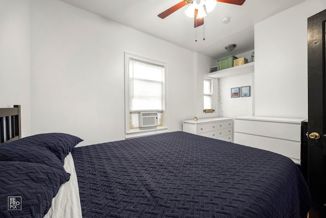 bedroom featuring cooling unit and a ceiling fan