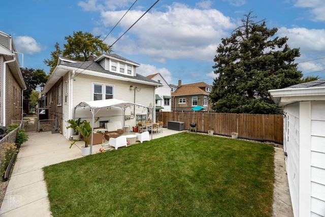 rear view of house with a patio, outdoor lounge area, and roof with shingles