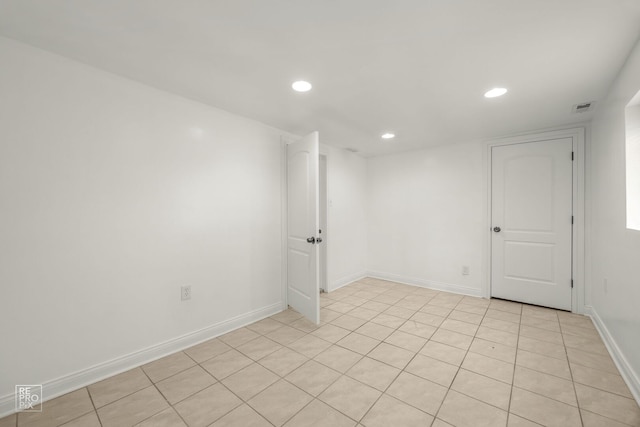 unfurnished room with recessed lighting, baseboards, and light tile patterned floors