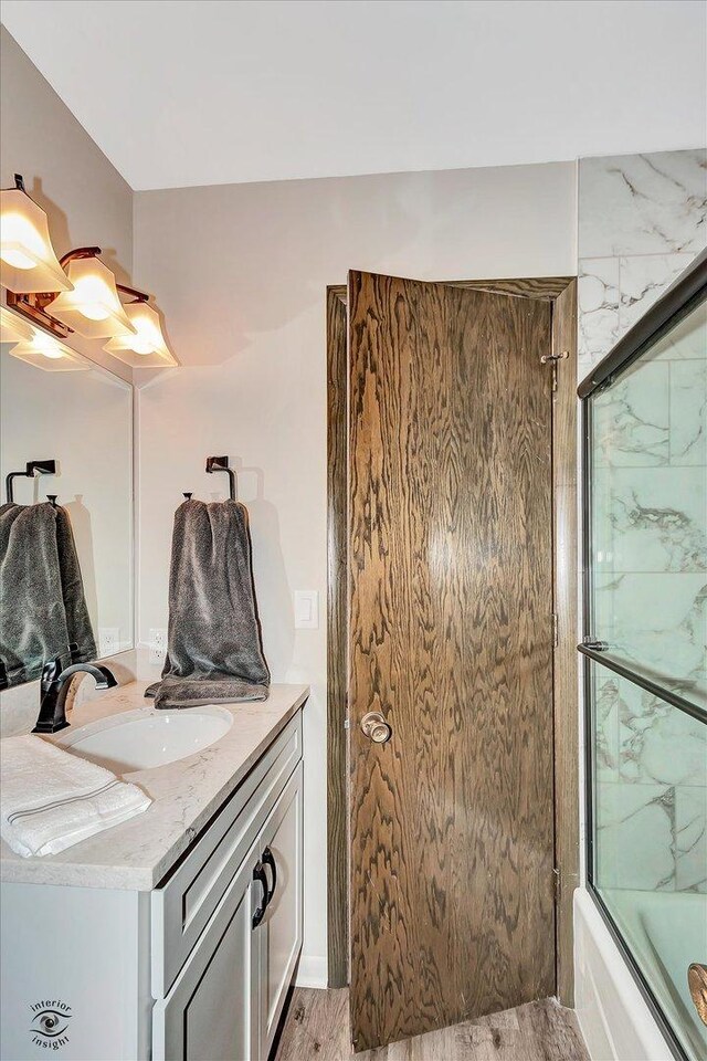 2958 N 1100 E Rd, Clifton, IL 60927 - full bathroom featuring vanity, enclosed tub / shower combo, and wood finished floors