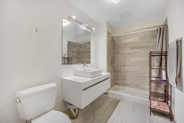 1345 S Wabash Ave Unit 710, Chicago, IL 60605 - bathroom featuring toilet, tiled shower, vanity, and wood finished floors