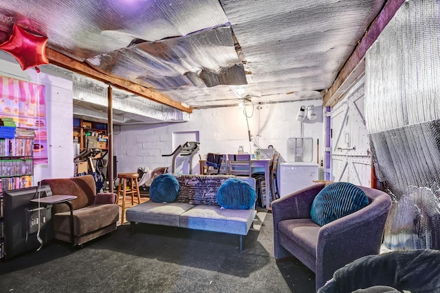living area featuring concrete block wall