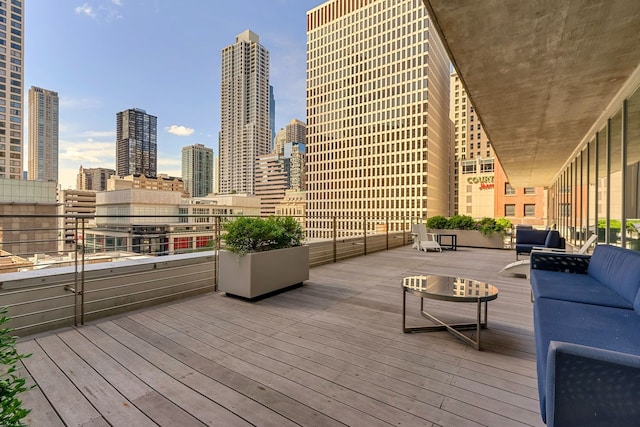 deck with outdoor lounge area and a skyline view