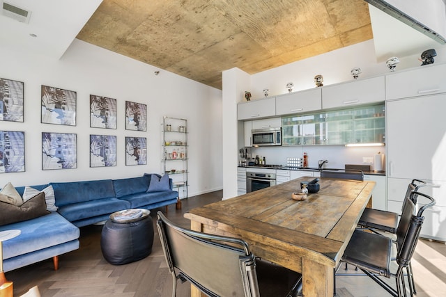 dining area featuring bar area and light wood-type flooring