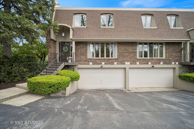 921 Harlem Ave Unit 1, Glenview, IL 60025 - front facade featuring roof with shingles, mansard roof, asphalt driveway, and brick siding