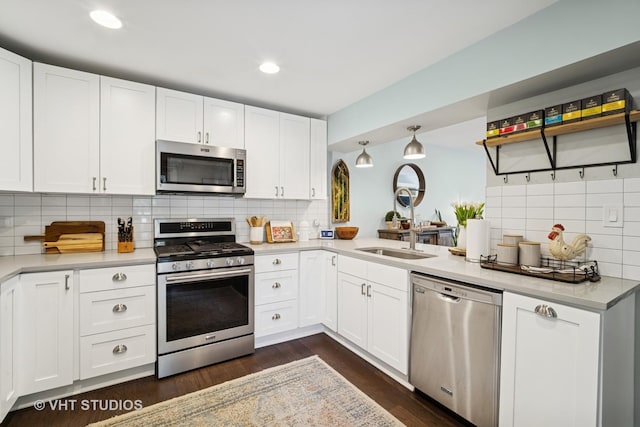 921 Harlem Ave Unit 1, Glenview, IL 60025 - kitchen with appliances with stainless steel finishes, backsplash, a sink, light countertops, and white cabinets