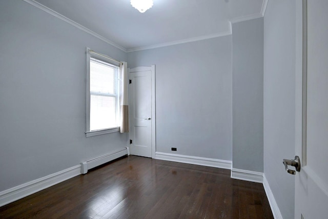 spare room featuring baseboard heating, dark wood finished floors, baseboards, and crown molding