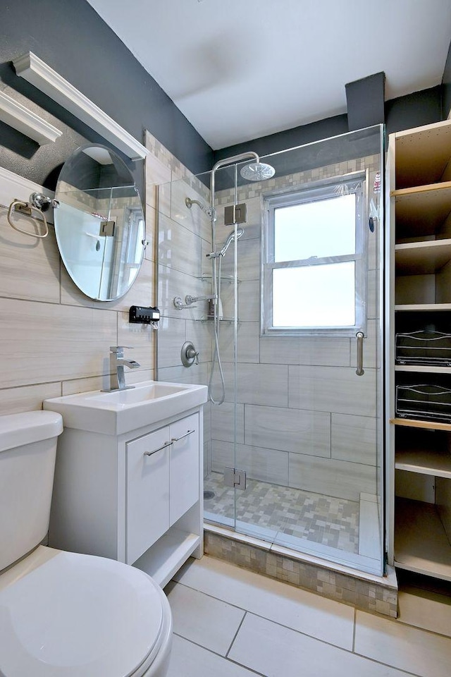 full bathroom with toilet, a shower stall, vanity, and tile patterned floors