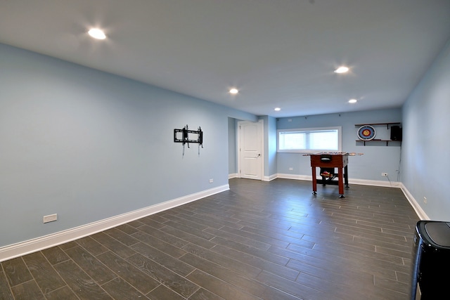 unfurnished room featuring dark wood-type flooring, recessed lighting, and baseboards