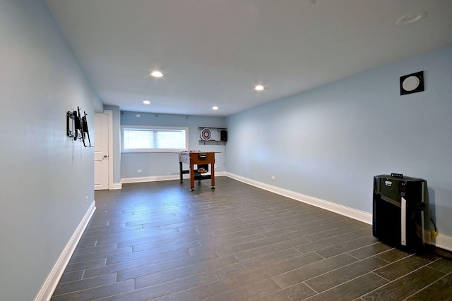 interior space with dark wood-type flooring, baseboards, and recessed lighting