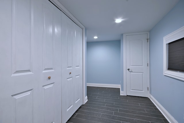 hall with baseboards, dark wood finished floors, and recessed lighting