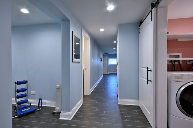 washroom featuring washer / dryer, a barn door, wood finished floors, baseboards, and recessed lighting
