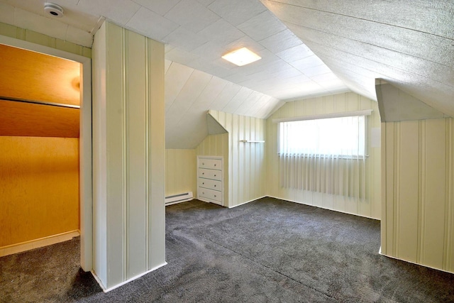 additional living space with carpet floors, a baseboard radiator, and lofted ceiling