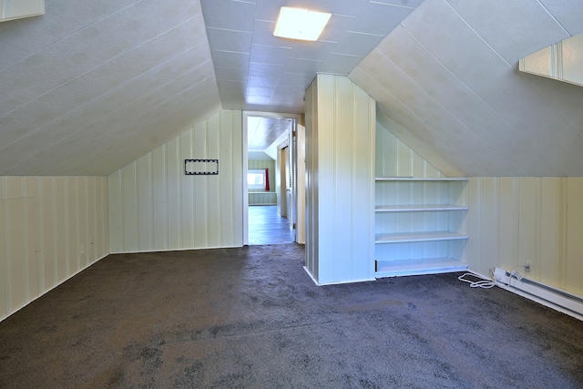 bonus room featuring carpet floors, vaulted ceiling, built in shelves, and wood walls