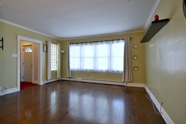unfurnished living room featuring a baseboard heating unit, ornamental molding, plenty of natural light, wood finished floors, and baseboards