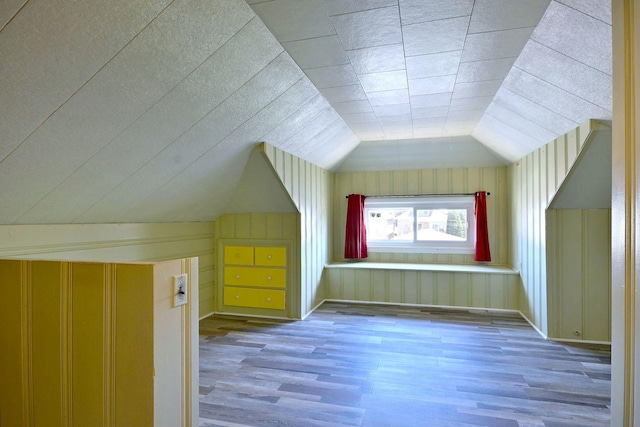 bonus room featuring wood finished floors and lofted ceiling