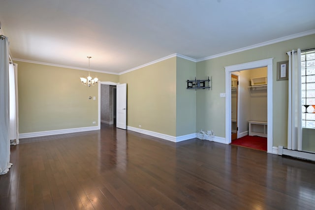 spare room featuring a chandelier, hardwood / wood-style flooring, crown molding, baseboards, and a baseboard heating unit