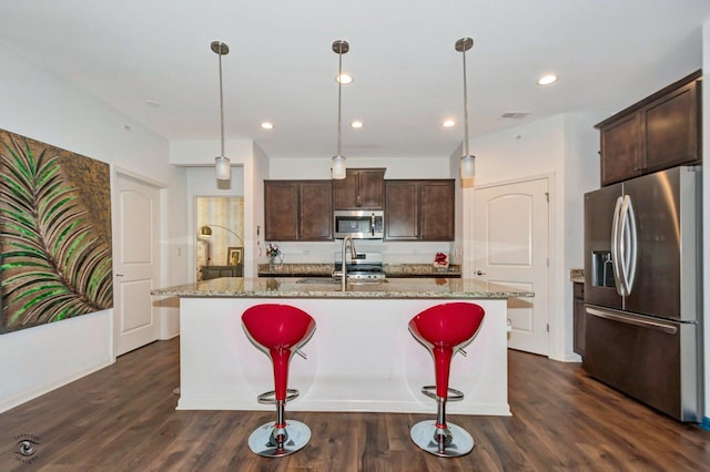 6359 Doral Dr, Gurnee, IL 60031 - kitchen with stainless steel appliances, dark brown cabinets, light stone counters, a sink, and recessed lighting