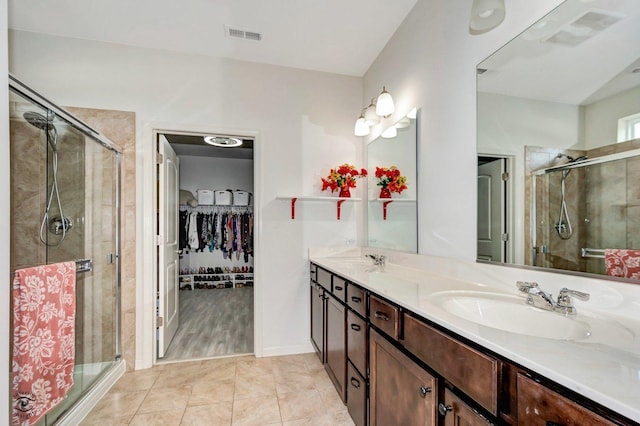 6359 Doral Dr, Gurnee, IL 60031 - bathroom with a stall shower, double vanity, and a walk in closet