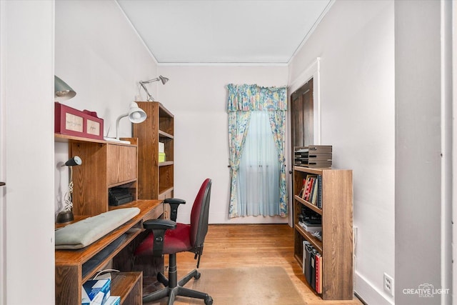 office area with ornamental molding and wood finished floors
