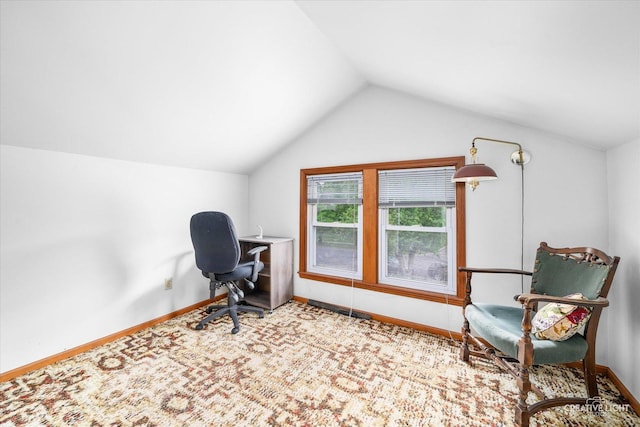 home office featuring lofted ceiling and baseboards