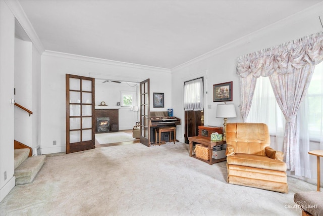 living area featuring stairway, crown molding, carpet floors, and a brick fireplace
