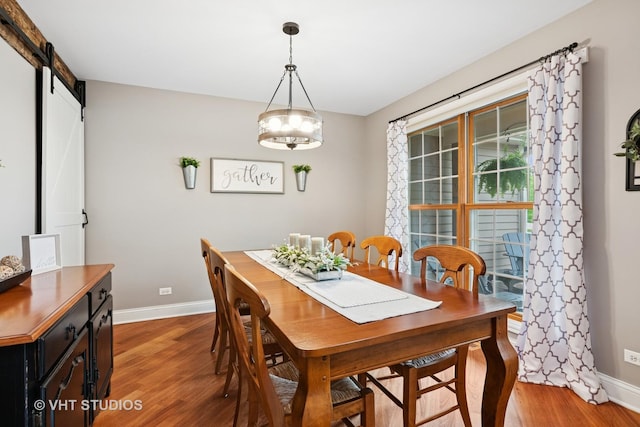 384 Edgewater Ct, Sugar Grove, IL 60554 - dining area featuring baseboards, light wood-type flooring, a barn door, and a chandelier