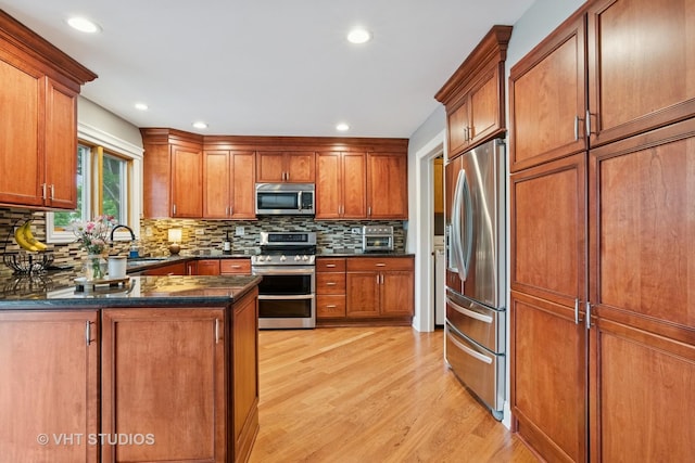 384 Edgewater Ct, Sugar Grove, IL 60554 - kitchen with appliances with stainless steel finishes, light wood finished floors, decorative backsplash, brown cabinetry, and recessed lighting