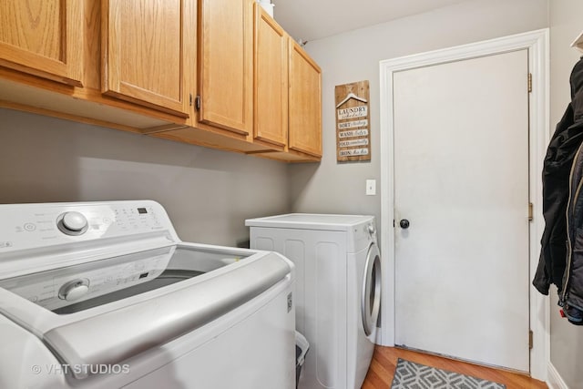 384 Edgewater Ct, Sugar Grove, IL 60554 - laundry room with washing machine and dryer, light wood-style floors, and cabinet space